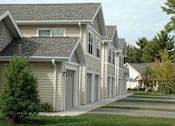 Thumbnail 6 of 18 - A row of houses with similar architecture and design.