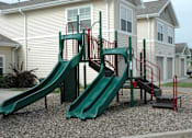 Thumbnail 2 of 18 - A green slide and stairs in front of a house.