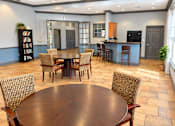 Thumbnail 7 of 14 - A dining room with a large table surrounded by chairs.