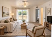 Thumbnail 11 of 14 - A living room with a couch, chair, and a painting on the wall.