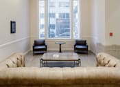 Thumbnail 2 of 5 - A living room with a couch, chairs, and a table.