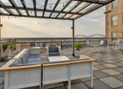 Thumbnail 12 of 39 - a rooftop terrace with couches and tables and a glass roof at Metro67, TN, 38103