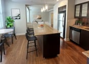 Thumbnail 6 of 39 - an open kitchen and dining area with a marble counter top at Metro67, Memphis, Tennessee