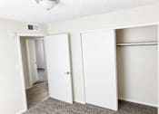 Thumbnail 7 of 9 - A white closet with two doors and a shelf.