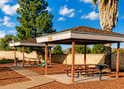 Thumbnail 1 of 9 - A picnic area with a shelter and benches.