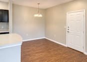 Thumbnail 41 of 46 - A room with a white door and a wooden floor.