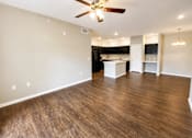Thumbnail 43 of 46 - A room with a ceiling fan and wooden flooring.