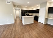 Thumbnail 46 of 46 - A kitchen with black cabinets and a white island.
