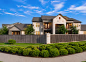 Thumbnail 3 of 46 - A large, modern house with a stone facade and a wooden fence.