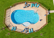 Thumbnail 5 of 46 - An aerial view of a swimming pool surrounded by a fence and lounge chairs.