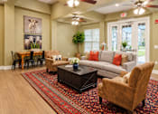 Thumbnail 24 of 46 - A living room with a couch, chairs, and a rug.