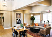 Thumbnail 22 of 46 - A living room with a grey couch and a coffee table.