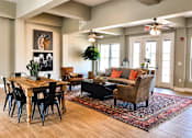 Thumbnail 18 of 46 - A living room with a wooden table and chairs.