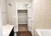 Thumbnail 35 of 46 - A bathroom with a toilet, sink, and bathtub.
