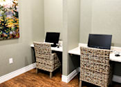 Thumbnail 31 of 46 - Two brown chairs are in front of two computers.