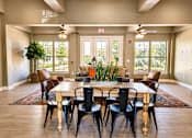 Thumbnail 26 of 46 - A dining room with a large table and chairs.