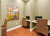 Thumbnail 29 of 46 - A room with a painting of a tree and three chairs.