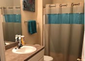 Thumbnail 5 of 7 - a bathroom with a sink and a shower and a toilet