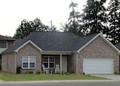 Thumbnail 4 of 7 - a brick house with a lawn and a white garage door