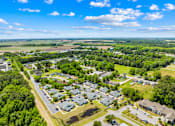 Thumbnail 3 of 11 - A bird's eye view of a residential area with houses and trees.