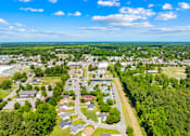 Thumbnail 6 of 11 - A bird's eye view of a residential area with houses, roads, and greenery.