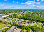 Thumbnail 7 of 11 - A bird's eye view of a residential area with houses, roads, and greenery.