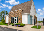 Thumbnail 2 of 17 - A small church with a parking lot in front.