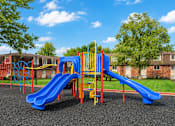 Thumbnail 5 of 17 - A playground with a blue slide and a yellow climbing frame.
