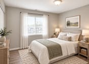 Thumbnail 15 of 17 - A bedroom with a large bed, a nightstand, and a window with curtains.