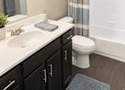 Thumbnail 17 of 17 - A bathroom with a white sink and a toilet.