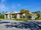 Thumbnail 4 of 14 - A row of houses with a tree in front of them.
