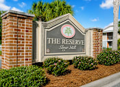 Thumbnail 3 of 14 - A sign that says "The Reserve Sugar Mill" is in front of a building.