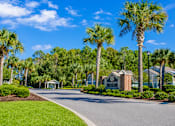 Thumbnail 1 of 14 - A street view of a residential area with a sign that reads "The Grove".