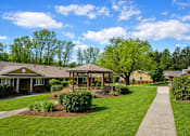 Thumbnail 3 of 9 - A sunny day at a park with a gazebo and a walking path.