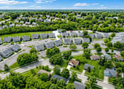 Thumbnail 9 of 9 - A bird's eye view of a residential area with houses and trees.