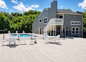 Thumbnail 2 of 9 - A large building with a pool in front of it.