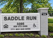 Thumbnail 5 of 9 - A sign for Saddle Run with contact information and a direction to the leasing office.