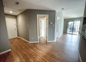 Thumbnail 8 of 26 - a living room with a hard wood floor and grey walls