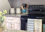 Thumbnail 17 of 26 - a kitchen with an oven and a counter top with a sink