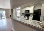 Thumbnail 21 of 26 - an open kitchen with a granite counter top
