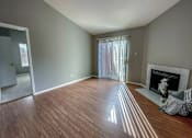 Thumbnail 16 of 26 - a living room with wood flooring and a fireplace