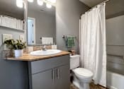 Thumbnail 11 of 26 - a bathroom with a sink toilet and a shower