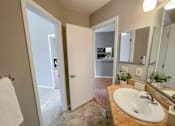 Thumbnail 6 of 26 - a bathroom with a sink and a mirror