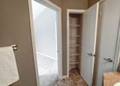 Thumbnail 9 of 26 - a small bathroom with a closet and a toilet and a sink