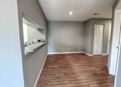 Thumbnail 7 of 26 - an empty living room with a sink and a mirror
