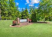 Thumbnail 2 of 10 - A sign in front of a green lawn that says "Oakcrest".