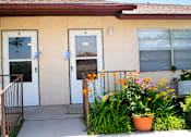 Thumbnail 2 of 12 - A house with a white door and a brown railing.