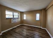 Thumbnail 25 of 43 - A room with brown walls and wooden flooring.