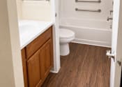 Thumbnail 6 of 12 - A white toilet is in a small bathroom with a walk-in shower.