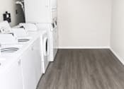 Thumbnail 9 of 12 - A laundry room with a washer and dryer.